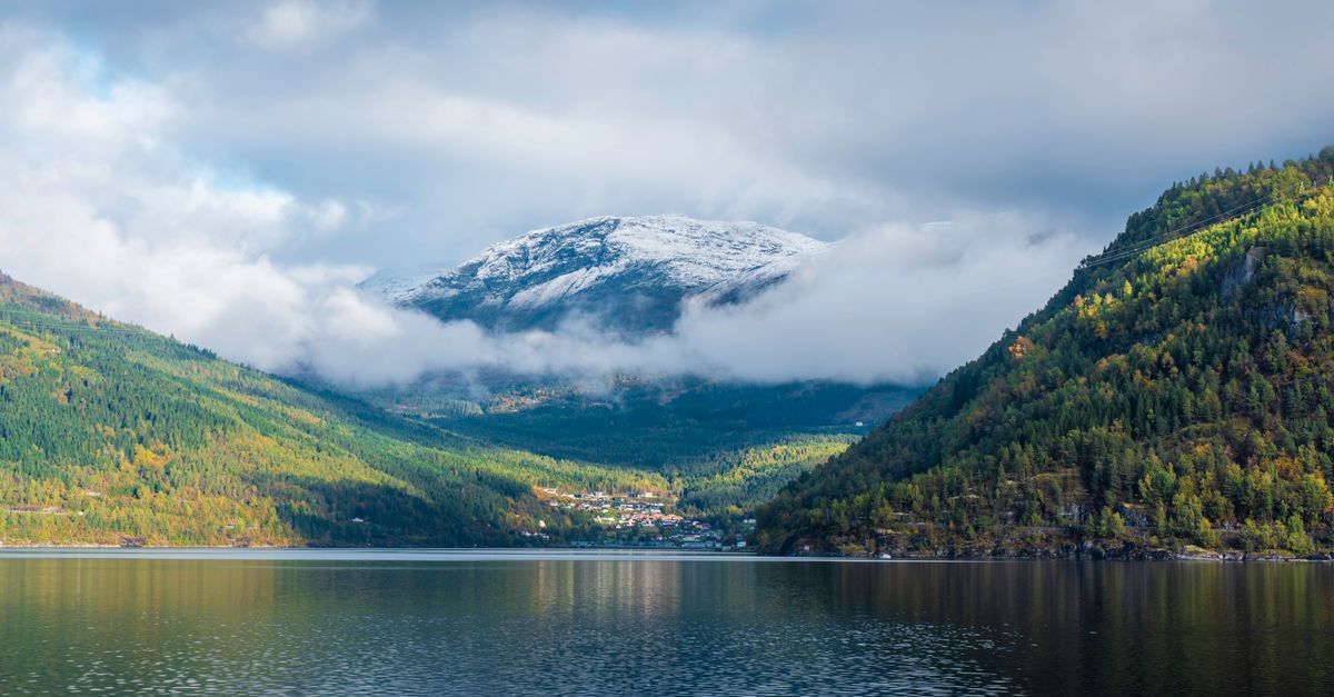 Stunning landscape of a Norwegian fjord with mountains and clouds.